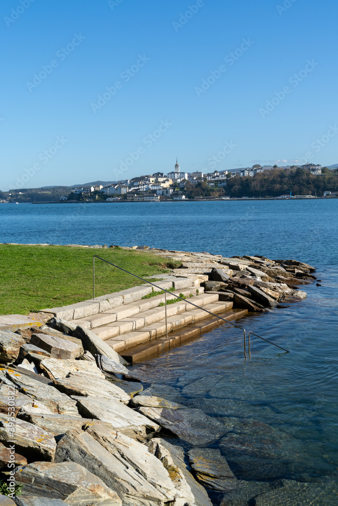 view of Castropol in Asturias across the Ribadeo River with the Praia dos Bloques in the foreground view of Castropol in Asturias across the Ribadeo River with the Praia dos Bloques in the foreground