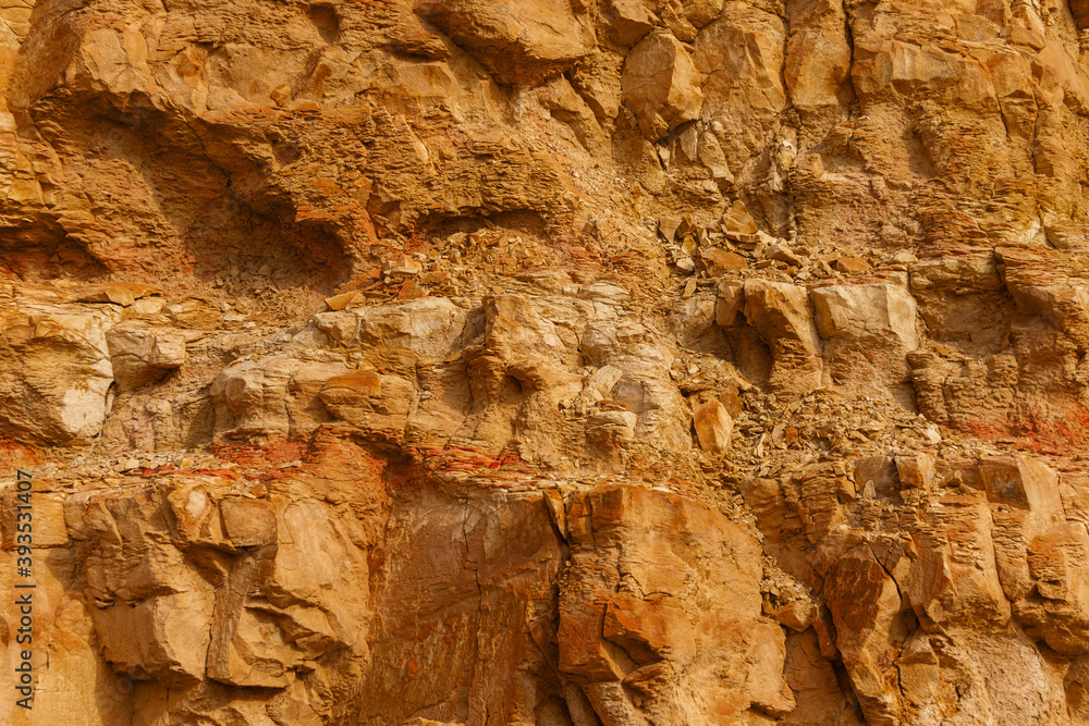 Fototapeta premium Stony slope of a sheer cliff. Textured background.