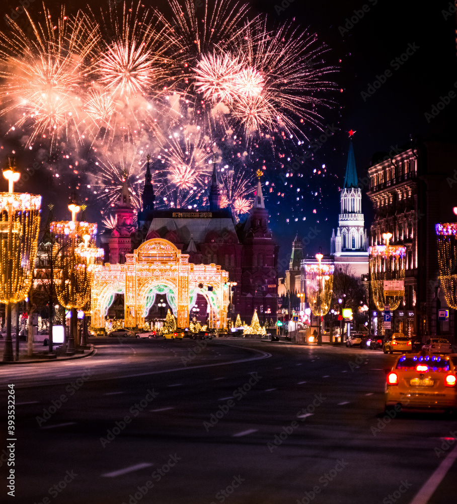Festive salute and fireworks on the red square in Moscow. Salute lights over the Kremlin and GUM at the New Year celebration. Multicolored salute for Christmas in Moscow at night, Russia