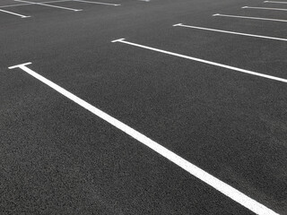 Parking markings, black and white stripes on bitumen. Empty Parking space at store
