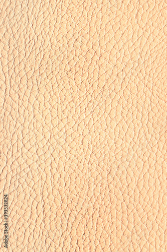 Beige leather background. Vertical photo.