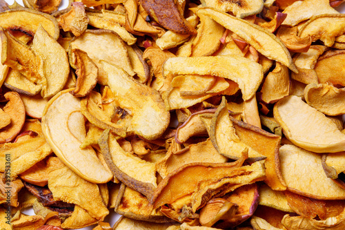 dried apple slices, dried fruit chips texture background, closeup. healthy food