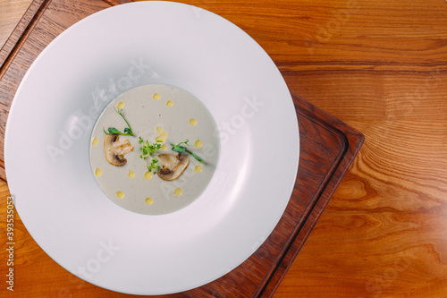 cream soup in a plate on a wooden table