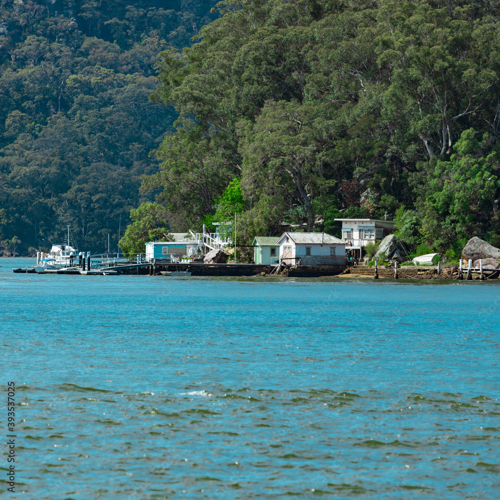 Boat Sheds amongst the trees on Hawkesbury River on Sydney Central Coast NSW Australia