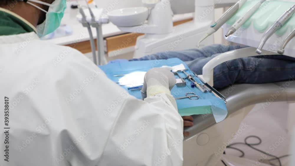 Dentist using tools during treatment in clinic Dentist using tools during treatment in clinic