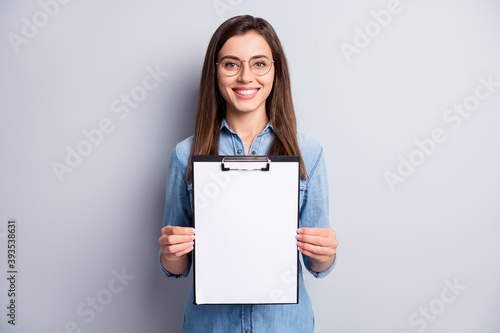 Photo of cheerful smart lady hands hold clip board showing list results isolated on grey color background