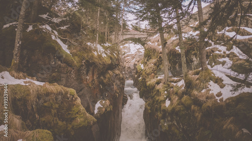 The Pont d   Espagne bridge on the river Gave du Marcadau  Cauterets. Beneath the bridge the river Gave du Marcadau tries to finds it way through a narrow gorge  creating a powerful rapid   waterfall.