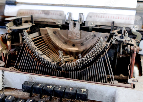 Broken metal typewriter. Vintage object Letters stick out