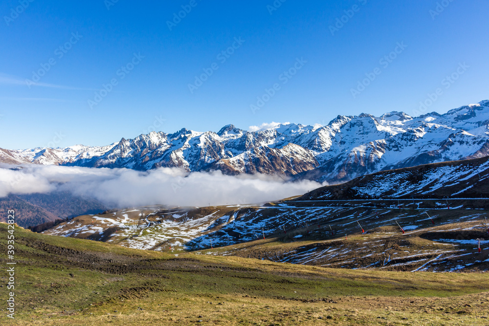 Snow and mountain peaks in the french Pyrenees near the Luchon Superbagnères Ski Resort in the Arrondissement of Saint-Gaudens, Occitania, Haute-Garonne, France. The Luchonnais Mountains aerial view.