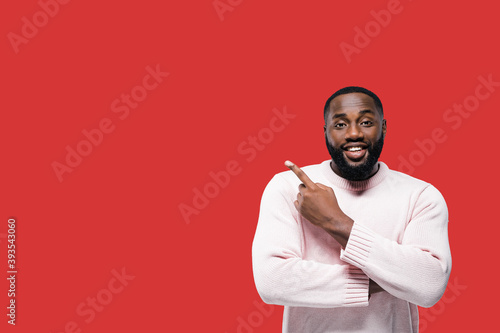 Canvastavla Smiling millennial man points for finger on copy space for your advertising or t