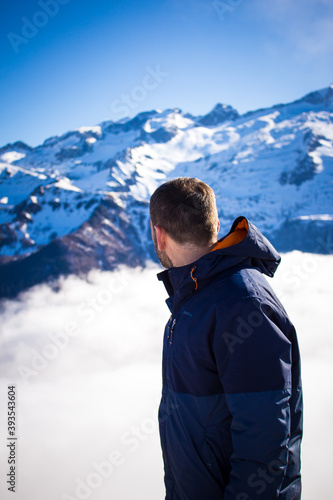 Man enjoying the stunning winter landscape. Concept of travel and adventure at Luchon Superbagnères Ski Resort in the Arrondissement of Saint-Gaudens, Occitania, France.