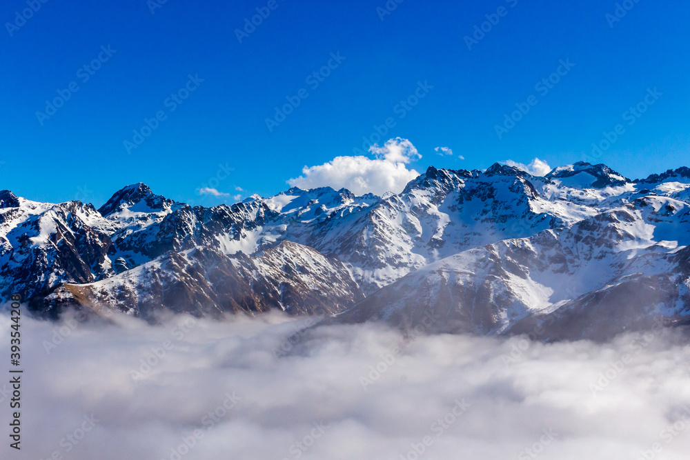 Snow and mountain peaks in the french Pyrenees near the Luchon Superbagnères Ski Resort in the Arrondissement of Saint-Gaudens, Occitania, Haute-Garonne, France. The Luchonnais Mountains aerial view.