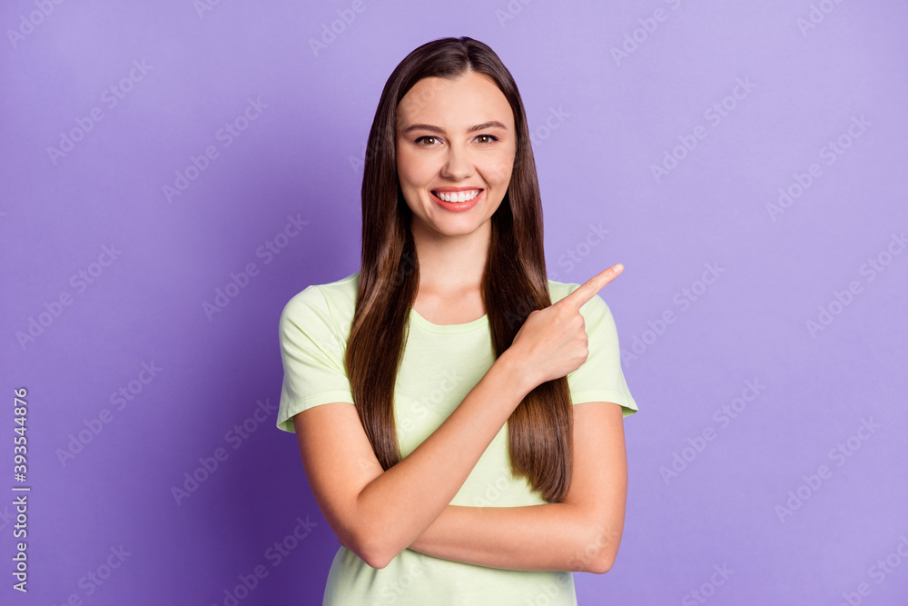 Portrait of attractive lady indicate finger empty space promotion isolated on pastel purple color background Portrait of attractive lady indicate finger empty space promotion isolated on pastel purple color background