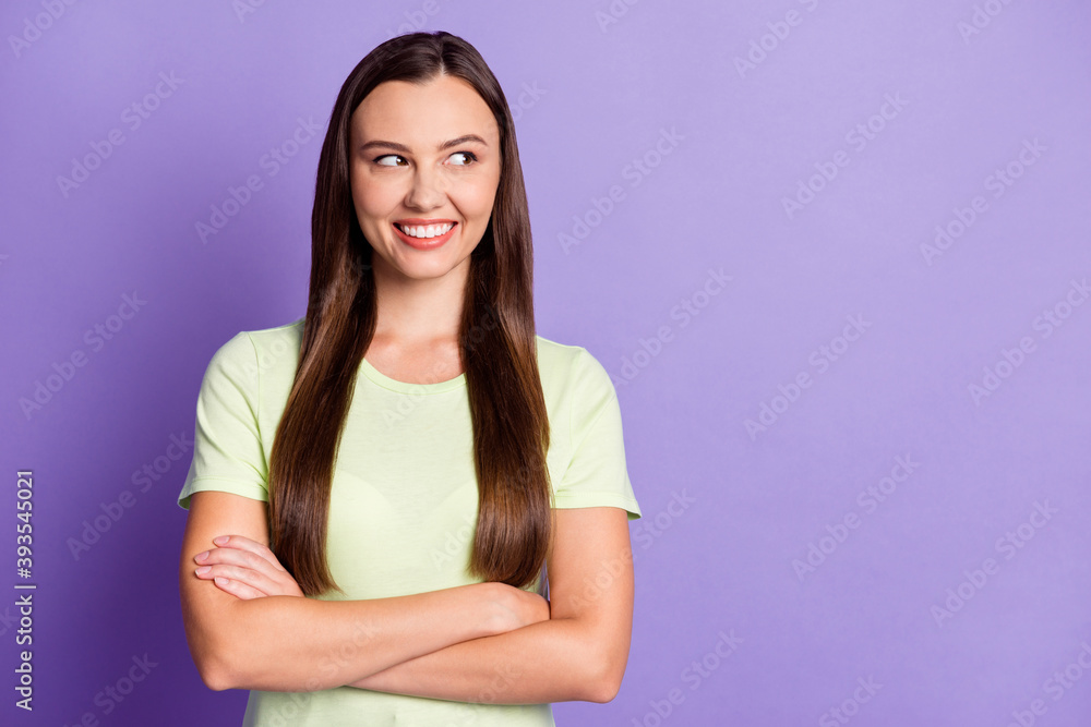 Portrait of attractive lady crossed hands look empty space toothy smile isolated on pastel purple color background Portrait of attractive lady crossed hands look empty space toothy smile isolated on pastel purple color background