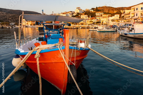 Rotes Fischerboot im abendlichen Hafen des Ferienorts Batsi auf der griechischen Kykladeninsel Andros photo