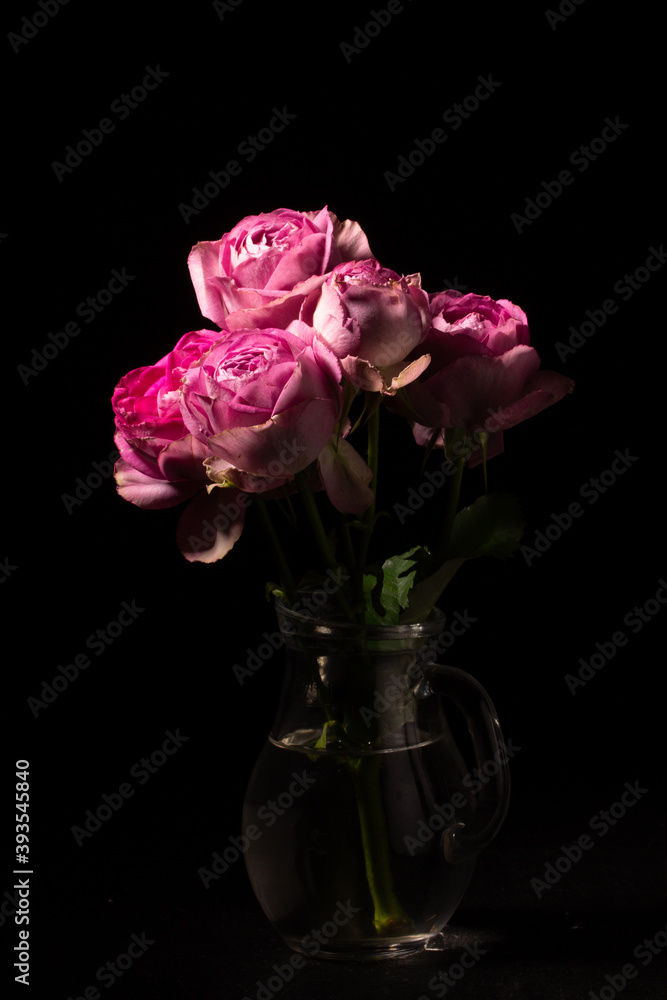 Bouquet of pink roses in a glass jug Bouquet of pink roses in a glass jug