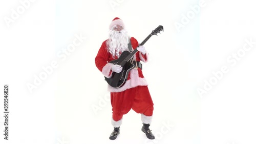 Santa Claus guitar player plays rock and roll. Santa is guitarist playing acoustic electric guitar, singing Christmas song on white background