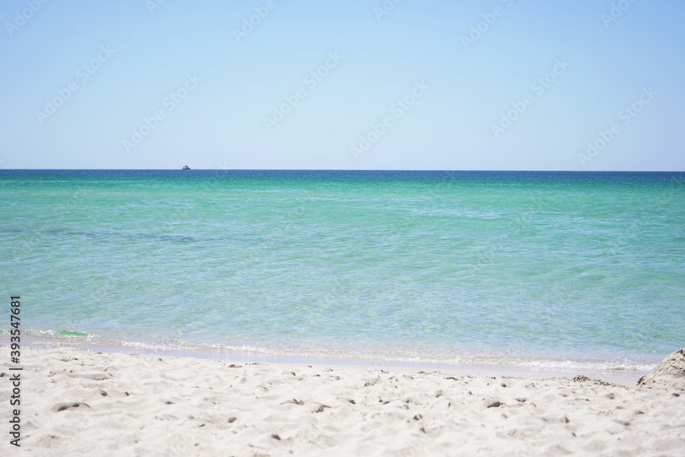 Beautiful sea view of the azure sea on a Sunny summer day on a sandy beach.