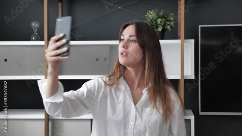 Cute bussineswoman tries to connect to a cellular network signal at home in modern interior. photo