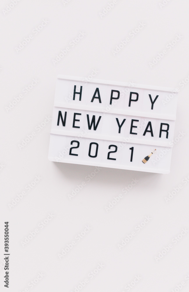 Light board with text Happy New Year 2021 on white background. Copy space, minimal. Light board with text Happy New Year 2021 on white background. Copy space, minimal.
