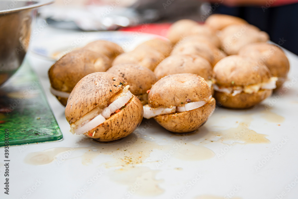 There are several raw potatoes on the dirty table that are ready to be fried. There are several raw potatoes on the dirty table that are ready to be fried.