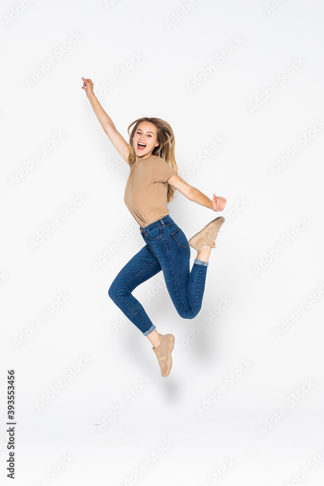 Portrait of a cheerful cute woman jumping isolated on a white background