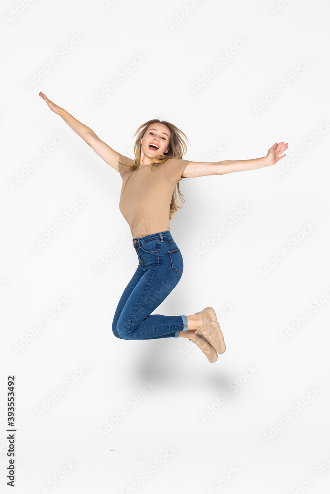 Portrait of a cheerful woman jumping isolated on a white background