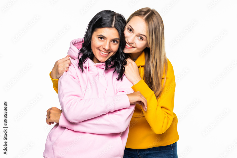 Pretty two women wear in casual hoodies and jeans isolated white background Pretty two women wear in casual hoodies and jeans isolated white background