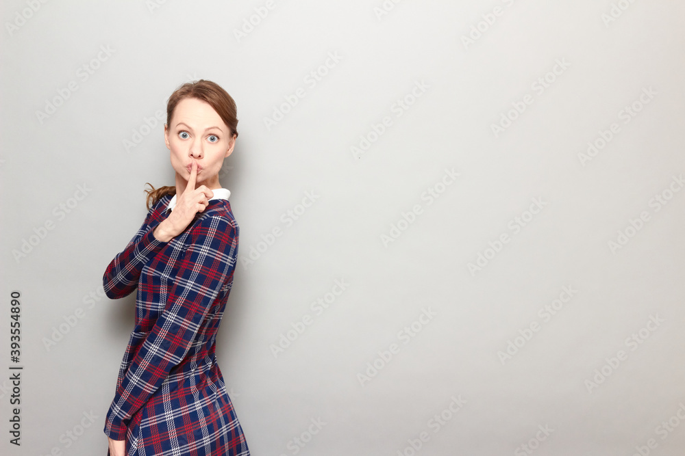 Portrait of girl showing silence gesture with finger over lips Portrait of girl showing silence gesture with finger over lips