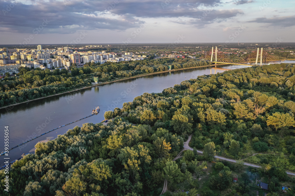 Naklejka premium Drone aerial view of River Vistula in Warsaw, capital of Poland - view from bank in Mokotow area