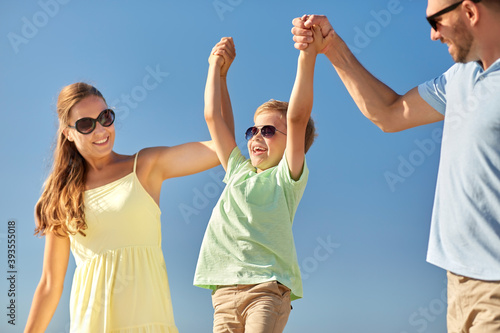 family, leisure and people concept - happy mother, father and little son having fun in summer © Syda Productions