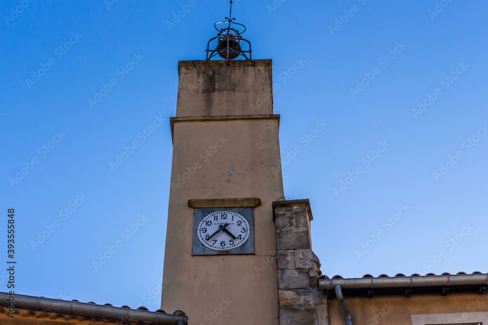 Carcassonne / France - March 11, 2020 - The Cité de Carcassonne is a medieval citadel in the department of Aude, Occitanie region. A Clock tower at Rue de la Trivalle street.