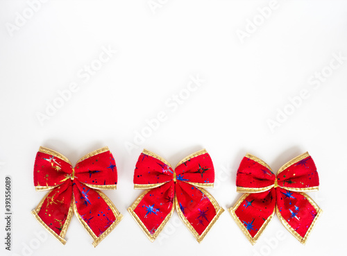 row of three red festive bows isolated on white background, christmas greeting card, copy space template