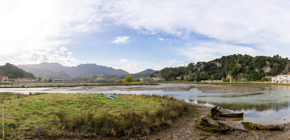 view of the estuary of the Sella River in Asturias at low tide with old row boat wrecks