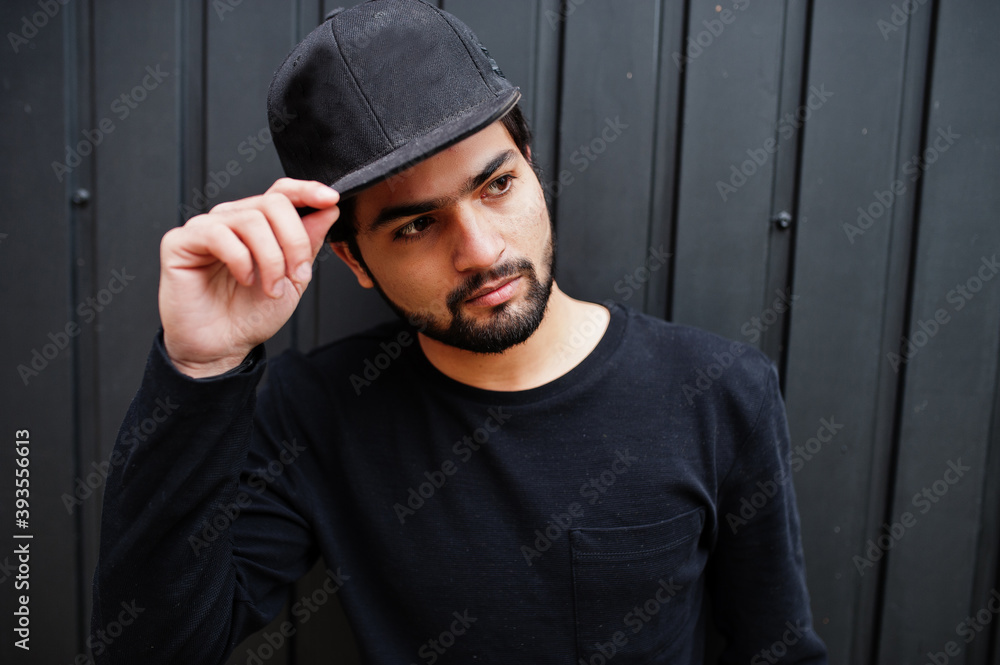 Urban young hipster indian man wear all in black. Cool south asian guy in full cap. Urban young hipster indian man wear all in black. Cool south asian guy in full cap.