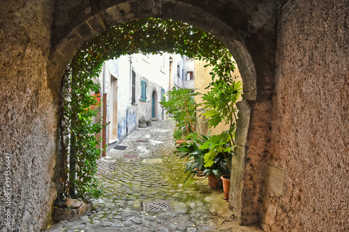 A narrow street between the old stone houses of Patrica, a mountain village in the province of Frosinone, Italy.