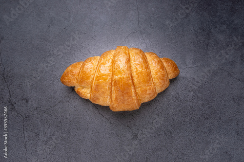 Delicious fresh croissant in on dark background. French breakfast. Tasty croissants with copy space