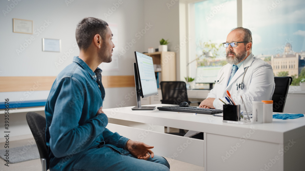 Latin Doctor Consultation Office: Male Patient Describes His Symptoms to Experienced Physician. Health Care Professional Offering Advice, Explaining Test Results, Prescription Medicine. Latin Doctor Consultation Office: Male Patient Describes His Symptoms to Experienced Physician. Health Care Professional Offering Advice, Explaining Test Results, Prescription Medicine.