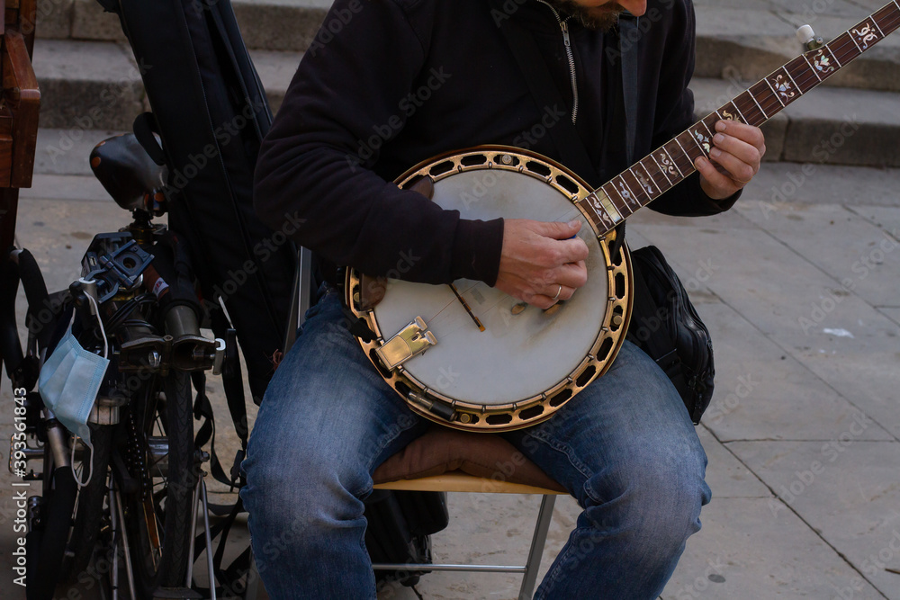 Fototapeta Closeup shot of a street musician playing the bandurria