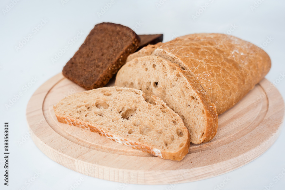 Freshly baked bread cutted into chunks on a wooden Board. Freshly baked bread cutted into chunks on a wooden Board.
