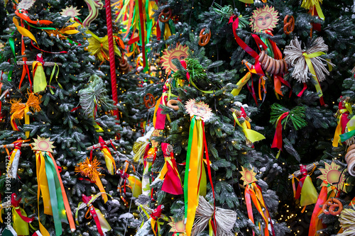 Christmas tree decorated with colored ribbons.