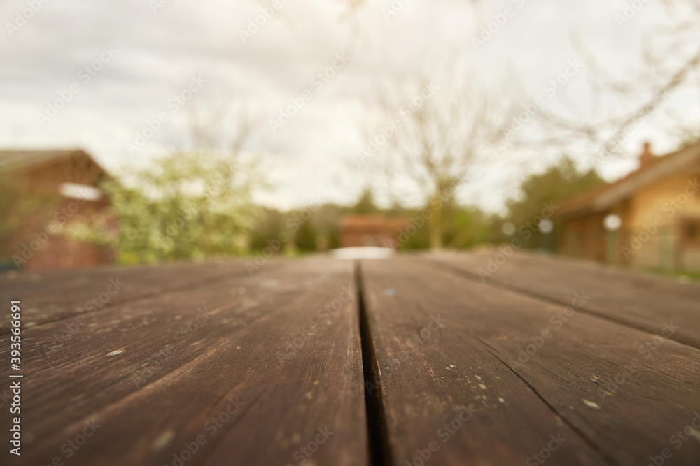 wooden table surface with blurred garden view wooden table surface with blurred garden view