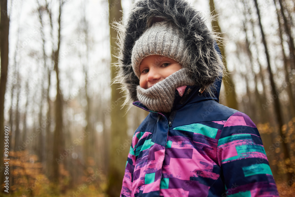 Autumn portrait of cute little caucasian girl in the cold forest Autumn portrait of cute little caucasian girl in the cold forest
