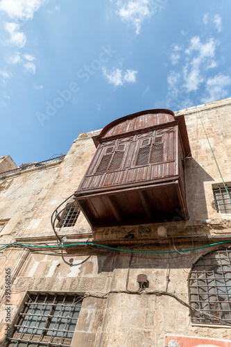 Decorative wooden external balcony on the wall of a building on the Shaar ha-Shalshelet Street in the old city of Jerusalem in Israel photo