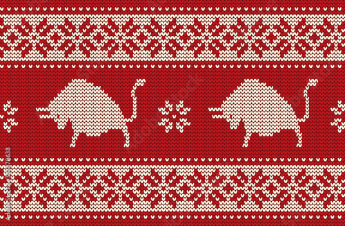 Knitted pattern with bulls. Ornament  in red and white colors. Seamless border. It can be used as a background to the New Year 2021. Year of the Ox. Vector illustration.