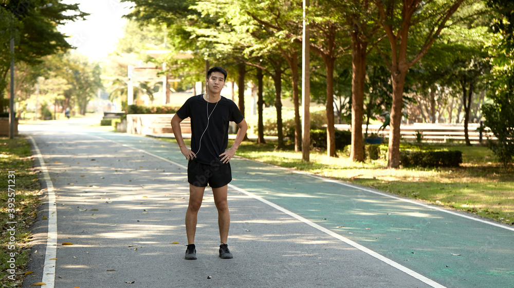 A young man walks outdoor as workout