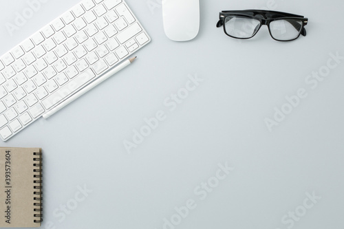 Glasses mouse pencil keyboard and notepad on white background