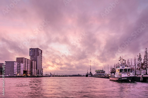 Rotterdam, The Netherlands, November 17, 2020: spectacular sky at sunset over Schiehaven harbour, surrounded by industry and residential neighbourhoods © Frans