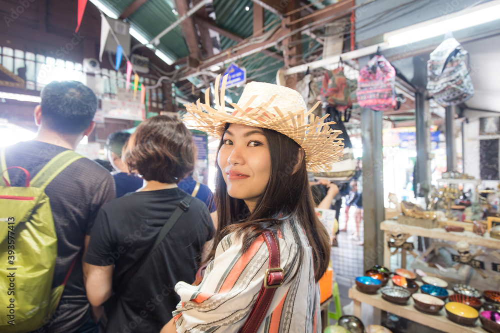 Woman travel in Bangkok city enjoy shopping in souvenir shop weekend market