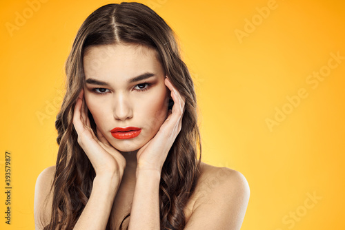 Woman with bare shoulders red cropped lips charm yellow background